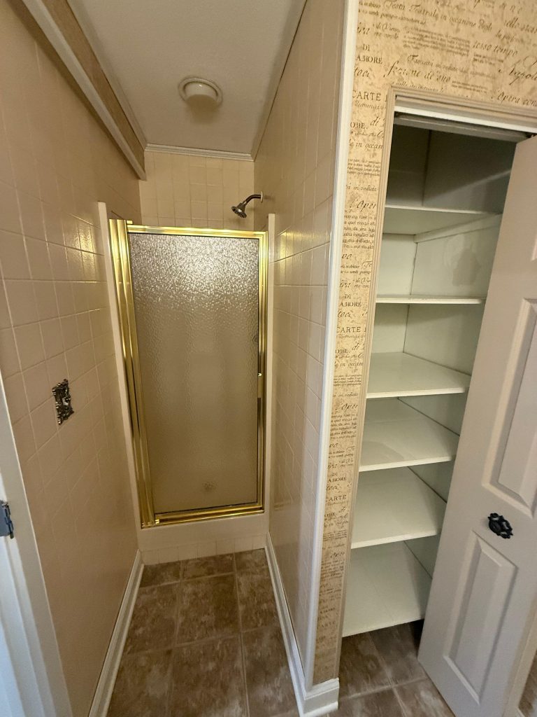Before photo of a Hoffman Estates bathroom remodel showing shower and floor conditions
