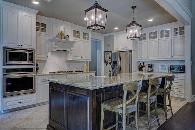 Kitchen remodel with cabinets lighting storage and island workspace